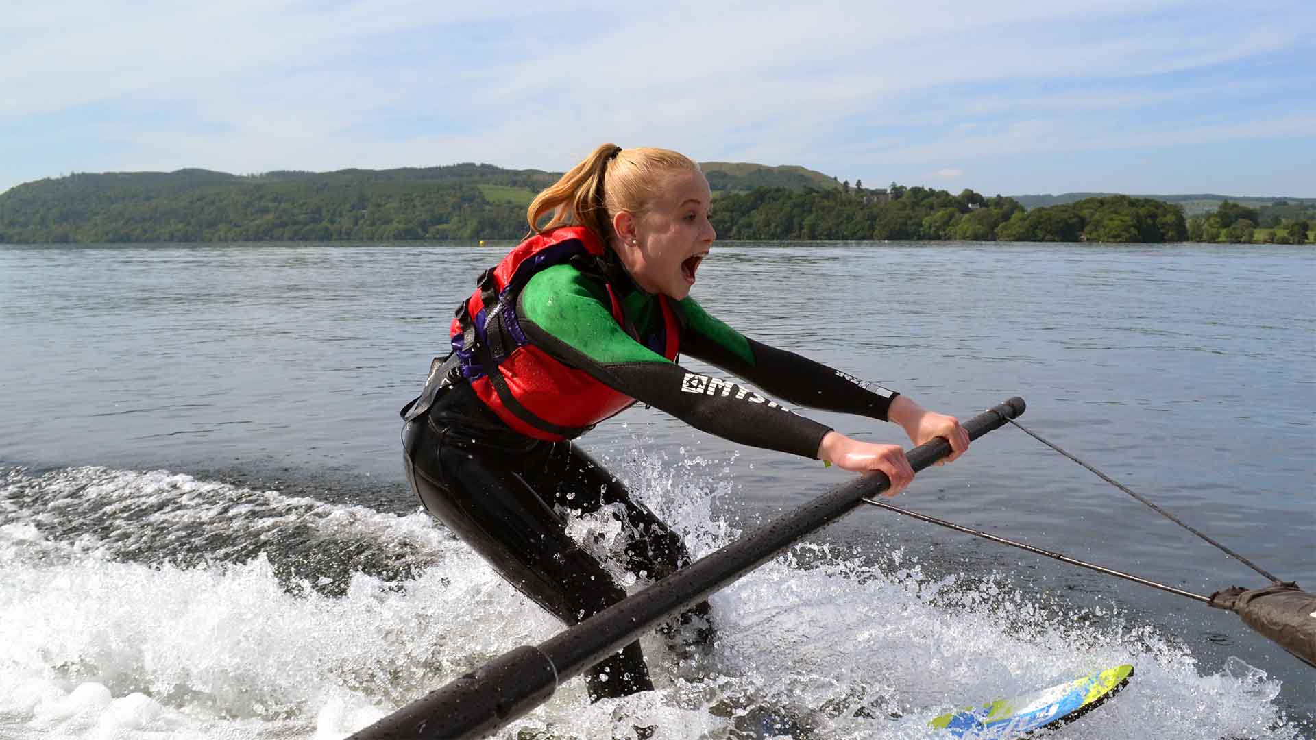 Young girl learning how to waterski on lake Windermere