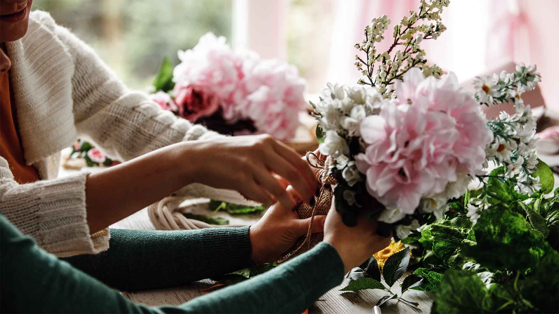 Women helping prepare flowers