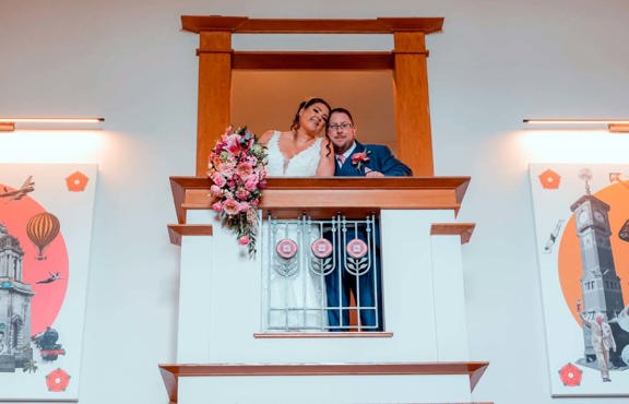 Newly weds stood on the Lancaster House Hotel reception balcony.