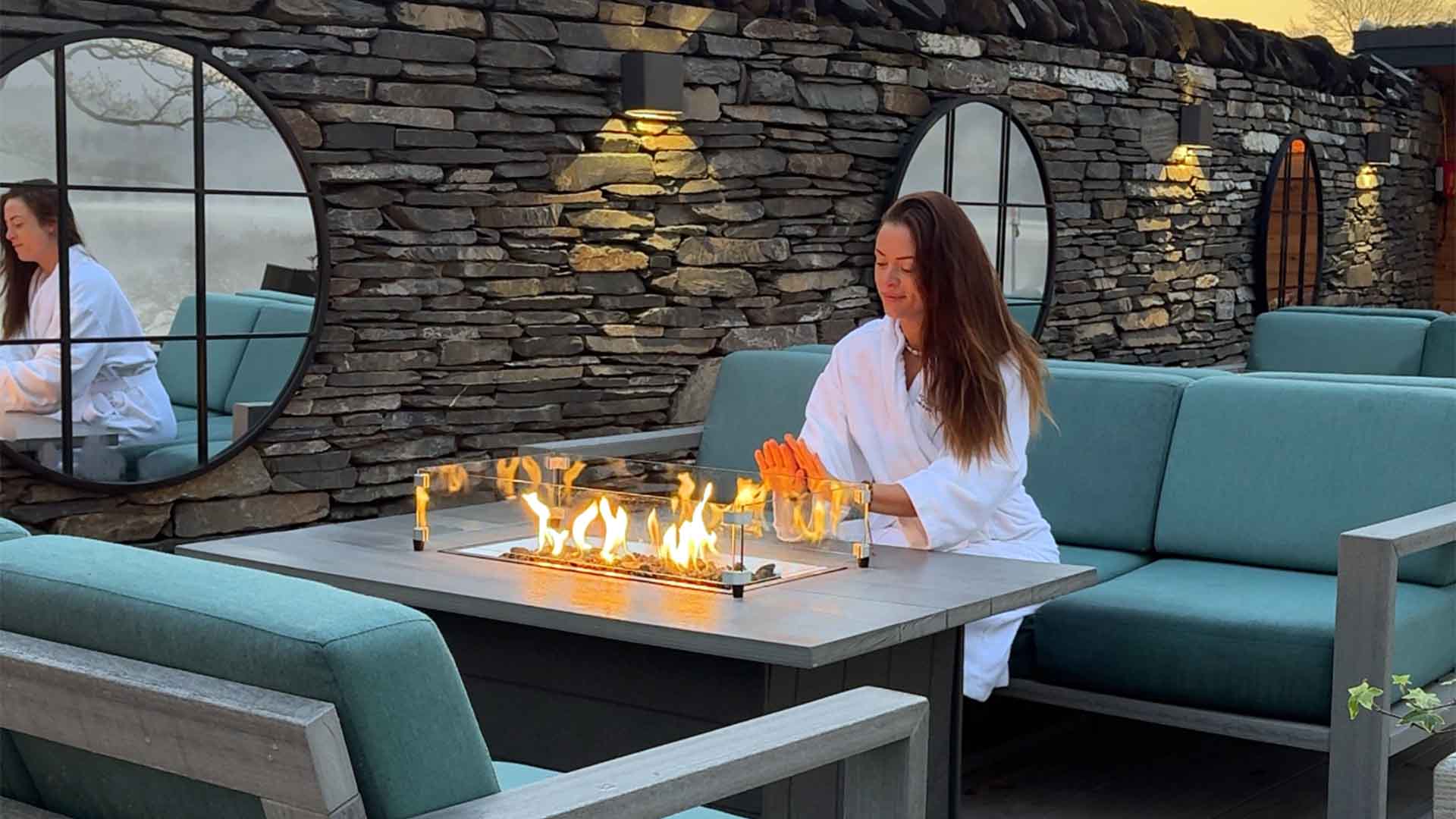 Young woman warming her hands by the poolside
