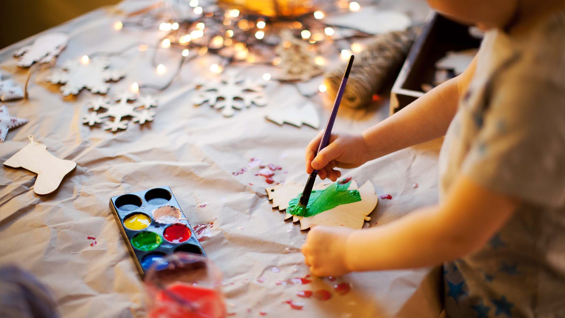 Young child colouring in with paints