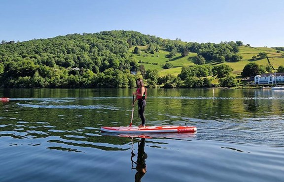 Young woman paddleboarding on Windermere