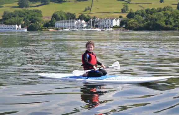 Young woman paddleboarding on Windermere