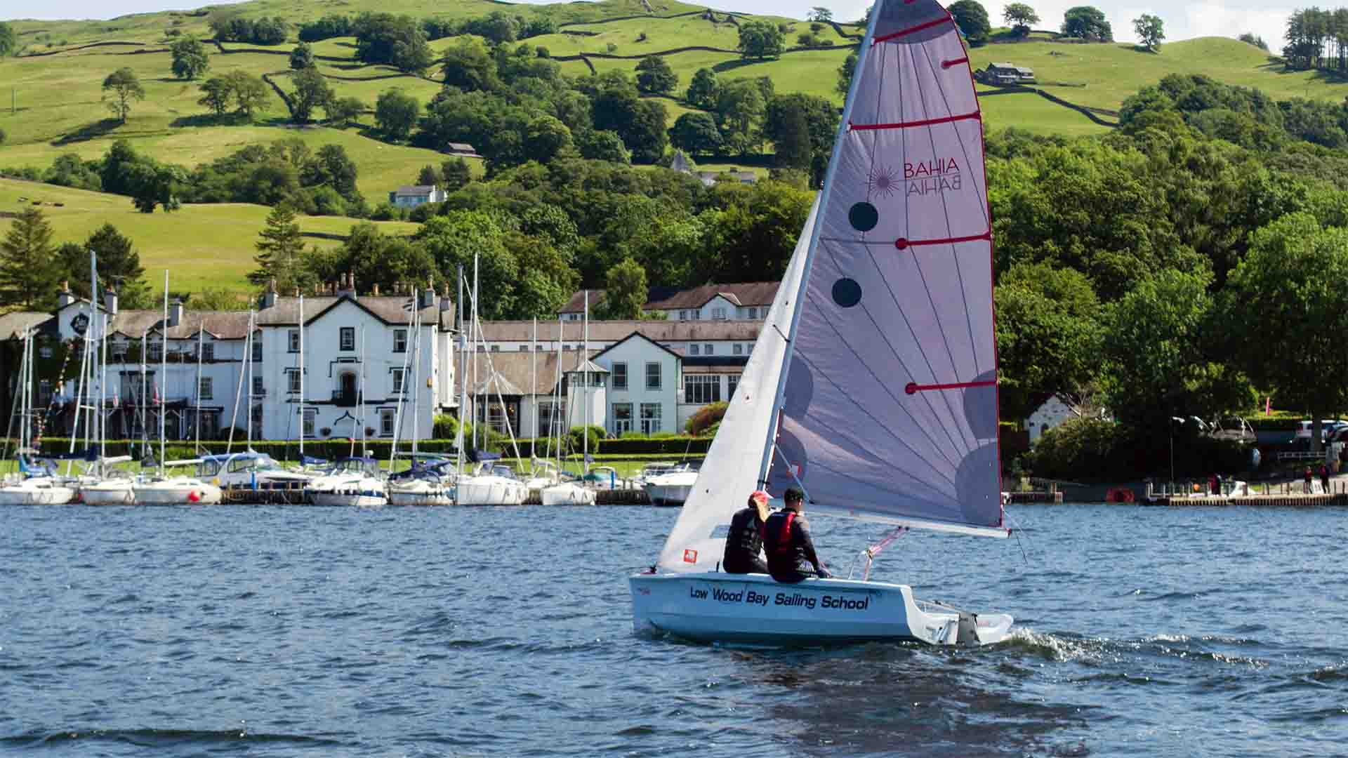 Laser Bahia sailing boat on lake Windermere in front of Low Wood Bay