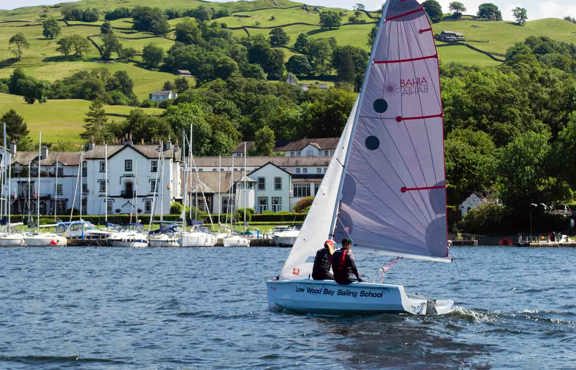 Laser Bahia sailing boat on lake Windermere in front of Low Wood Bay