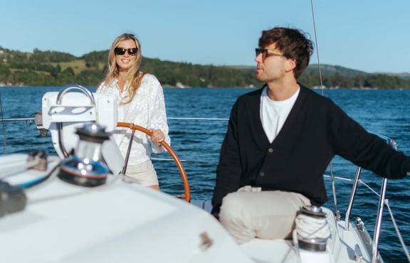 Young woman at the helm of a chartered yacht on lake Windermere