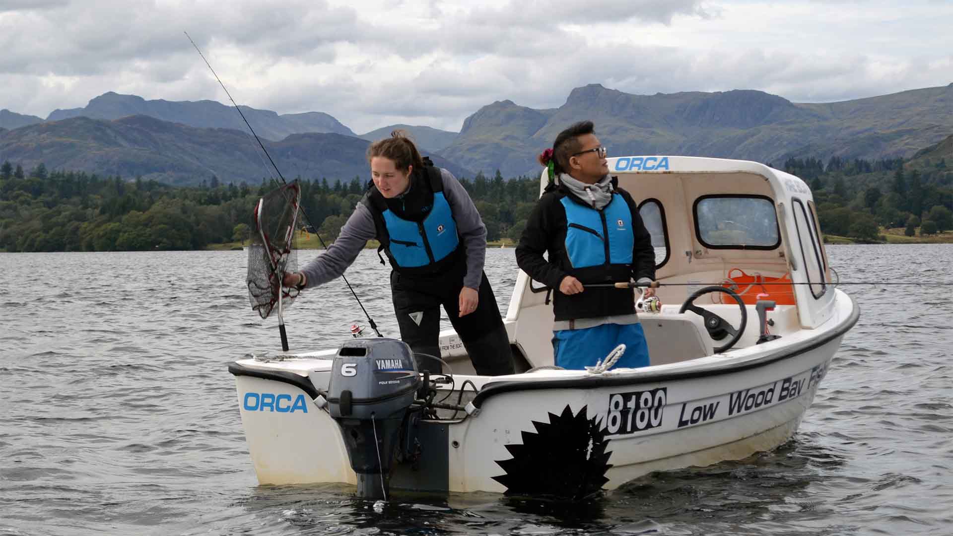 A hire fishing boat with 2 aboard on lake Windermere