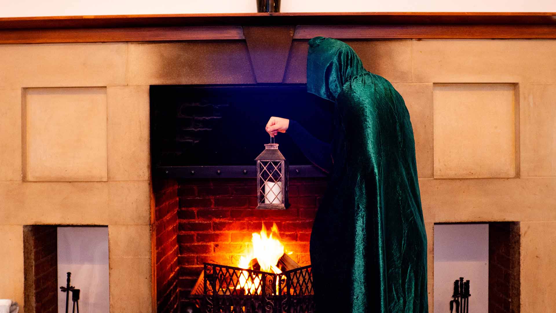 Cloaked figure by the Lancaster House Hotel fireplace