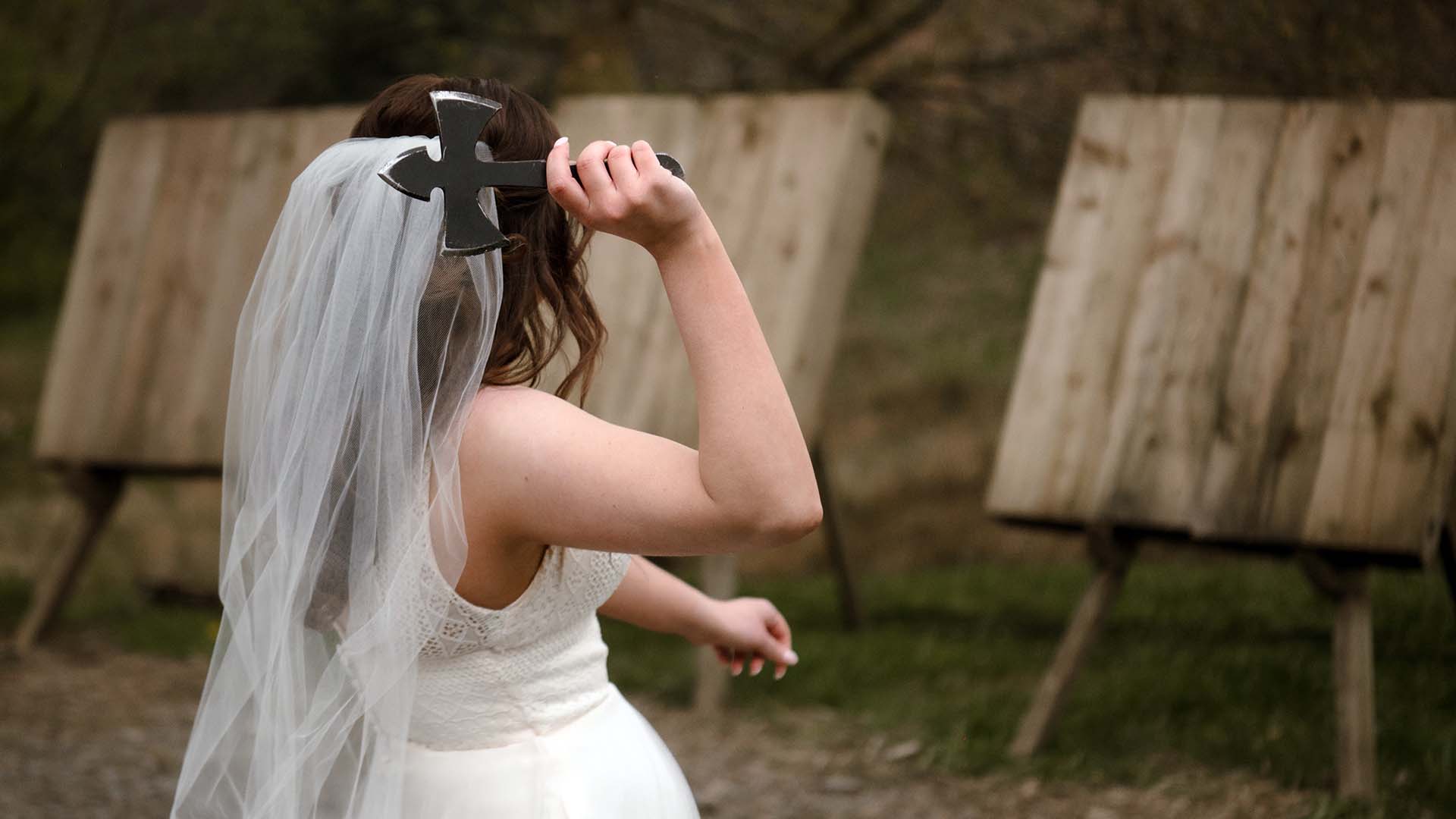 Bride throwing her axe towards the target at Wild Boar Estate