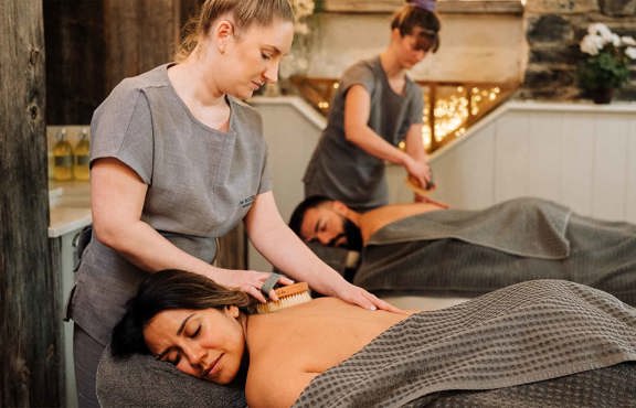 Couple receiving a back treatment in the Spa