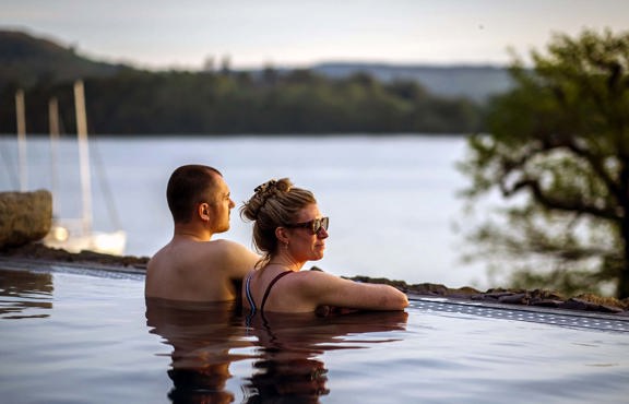 Couple in vitality pool looking at view