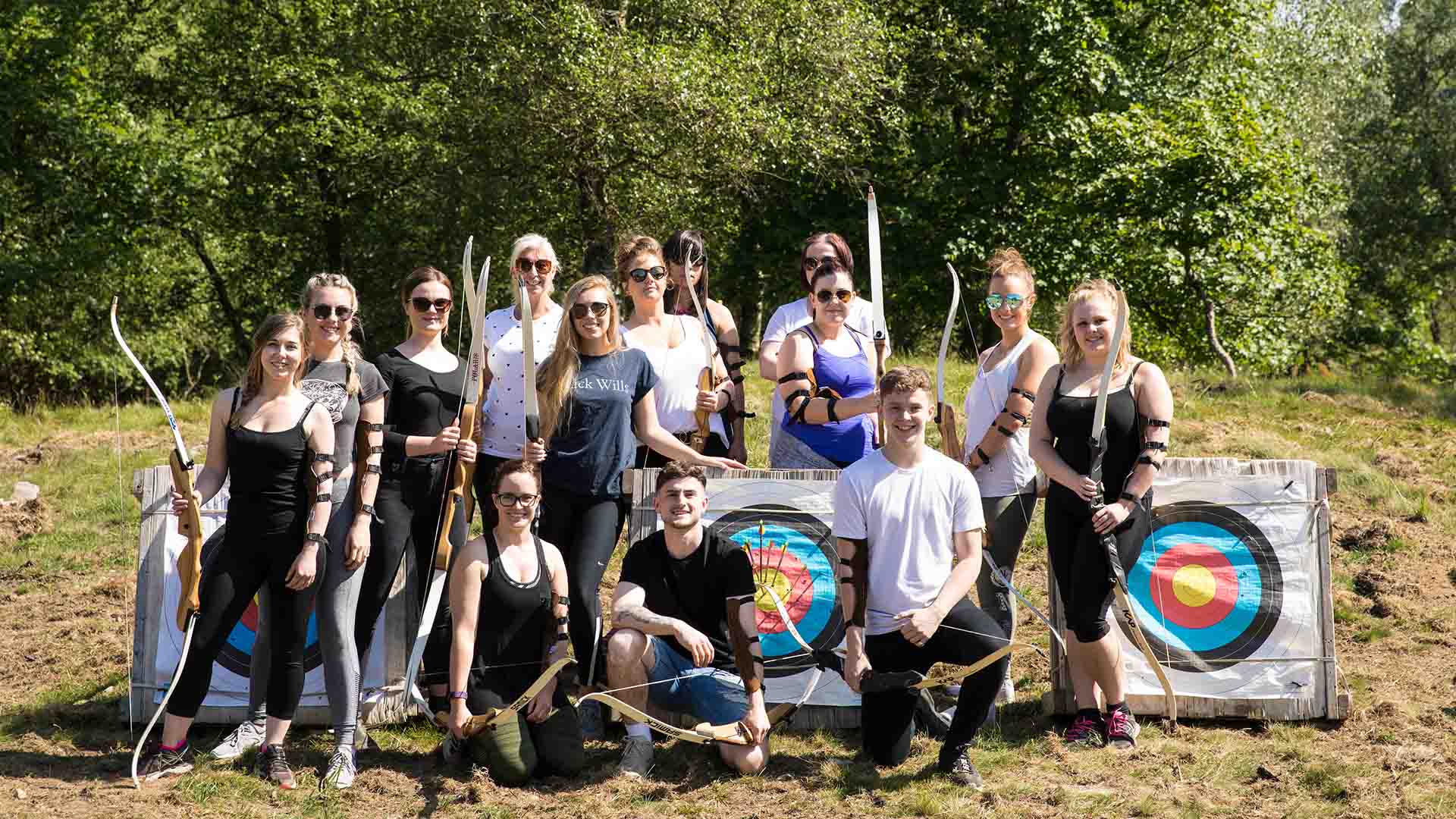Large group enjoying an archery session at The Wild Boar Estate