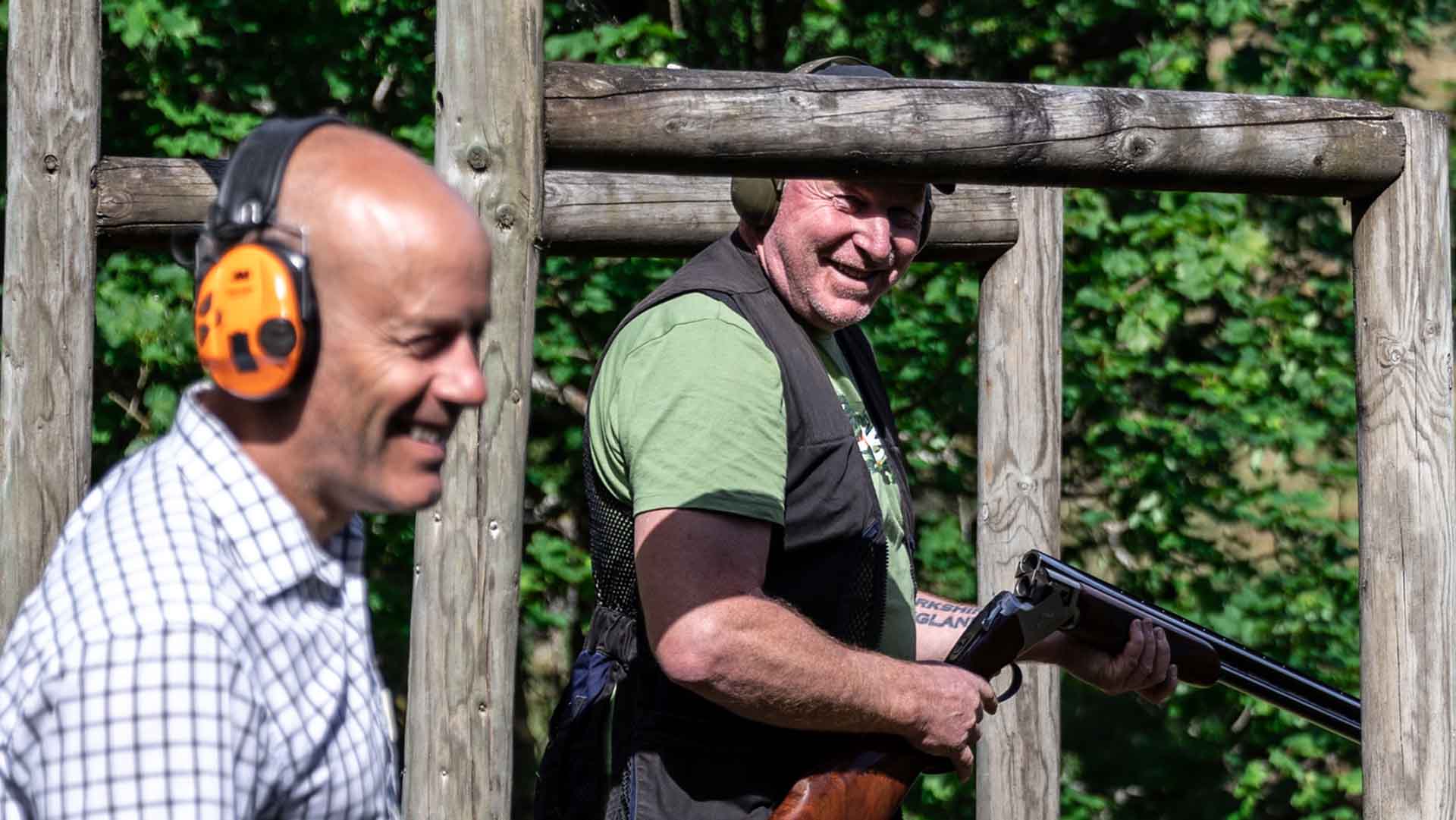 Mike Coates and a clay pigeon shooting participant enjoying a joke