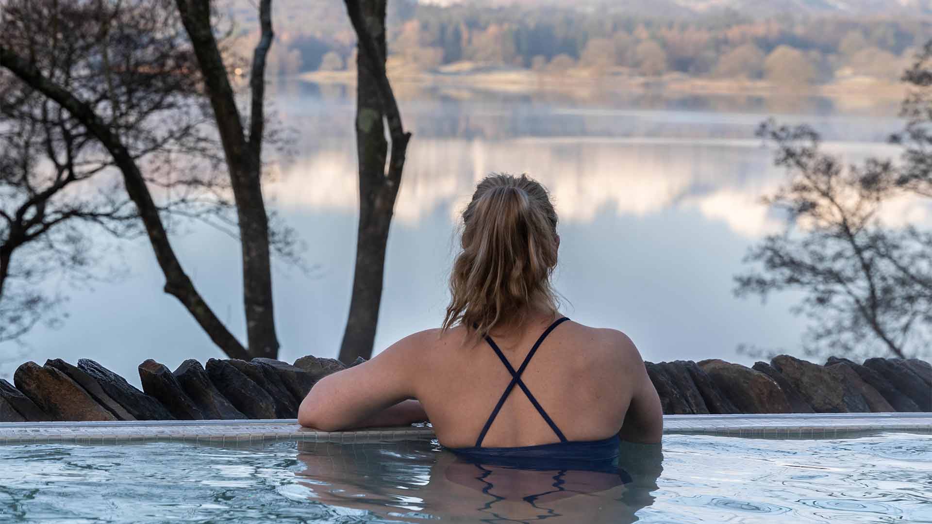 Young woman looking out over the lake from the infinity view pools