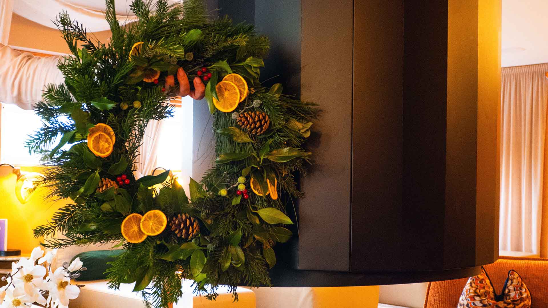 A Christmas wreath held by the fire in the Fellview Lounge at The Spa