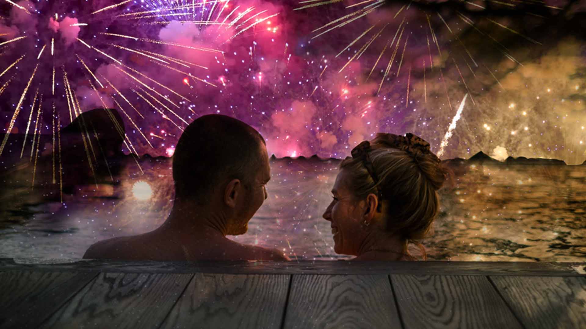 Couple sat in the outdoor pool watching fireworks