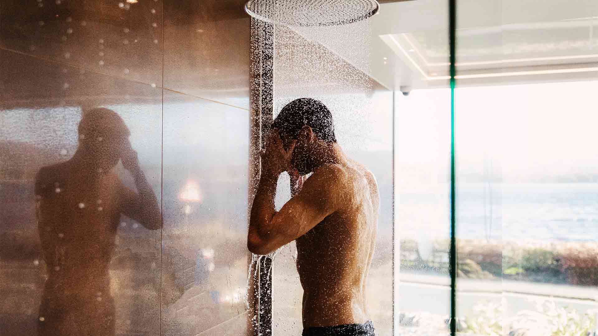 Young man taking a shower in the indoor thermal space at the Spa