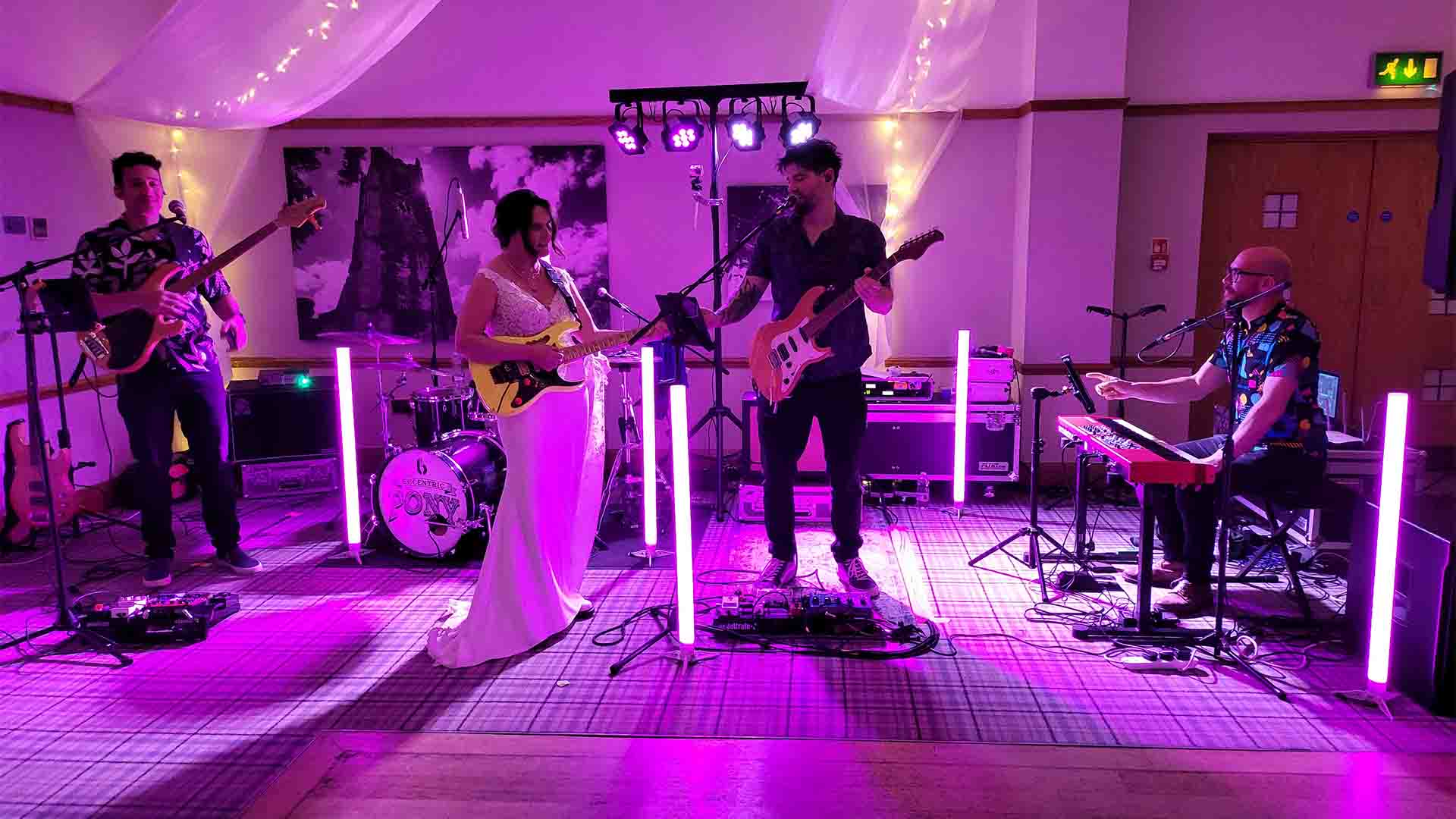 Bride playing guitar with the band