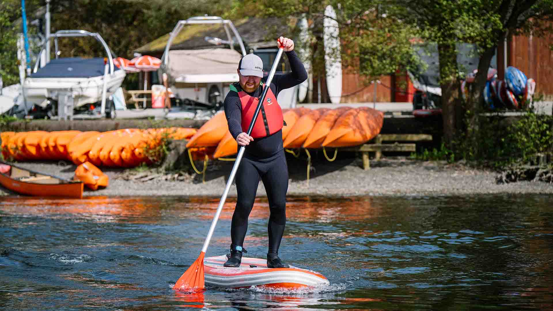 Man paddleboarding on lake Windermere