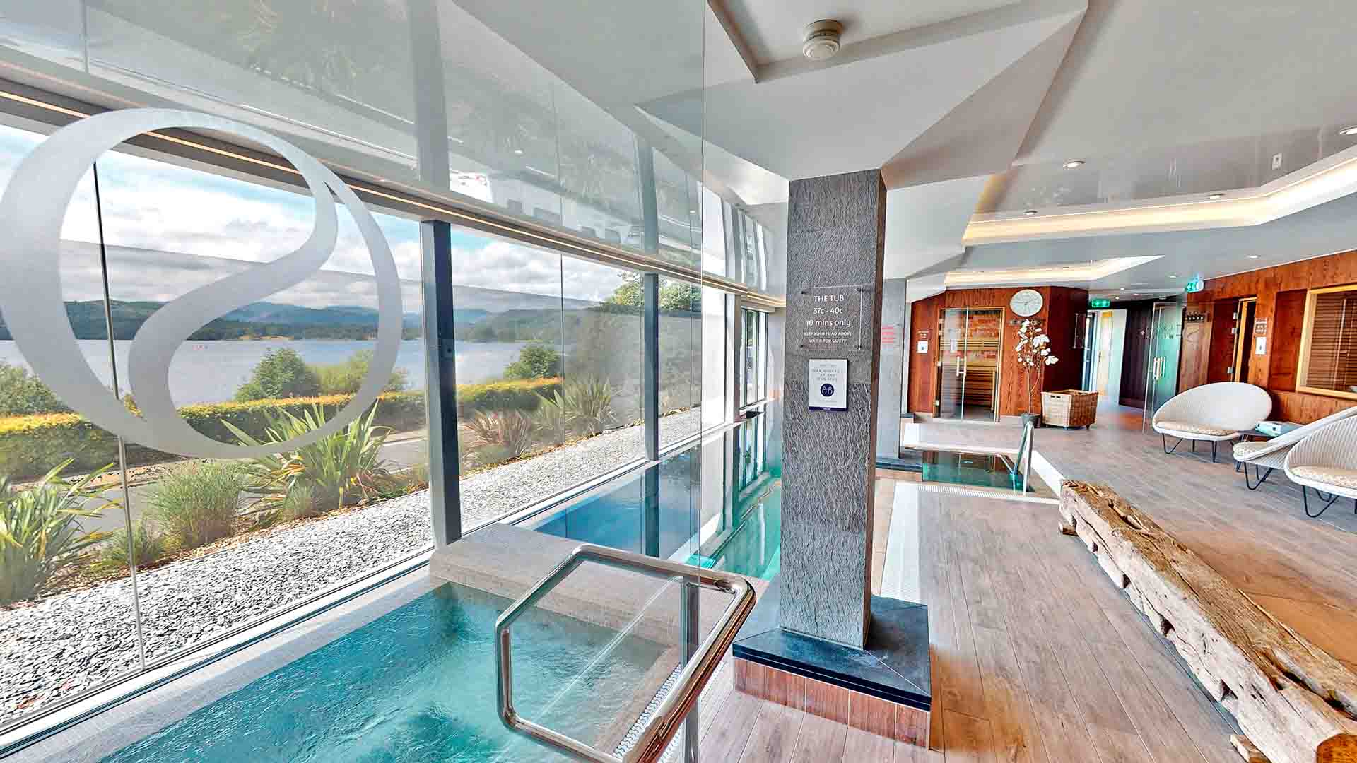 The spa's indoor relaxation pool with view over Windermere in distant fells