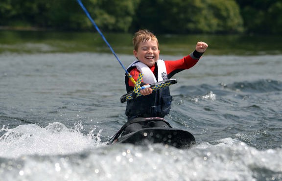 Young boy enjoying kneeboarding