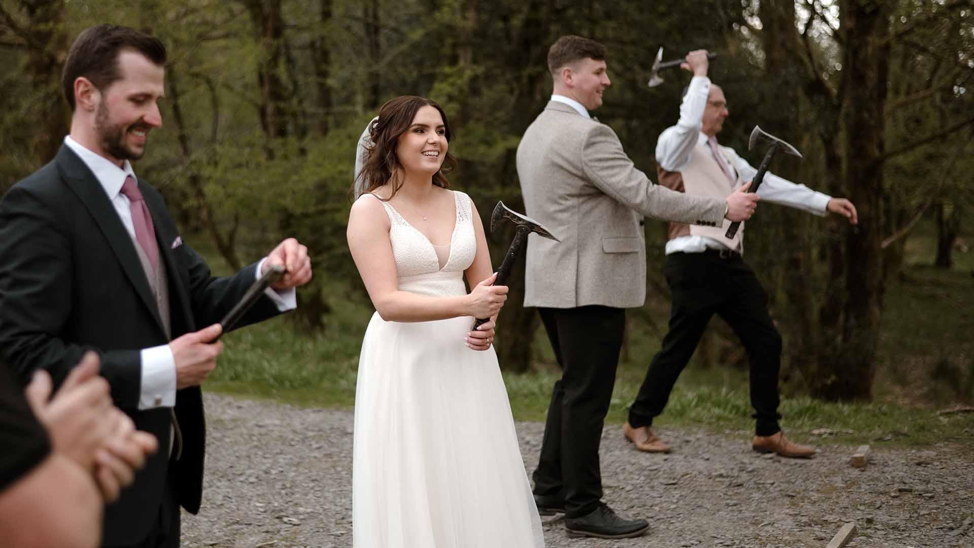 Wedding party taking part in an axe throwing activity at Wild Boar Estate