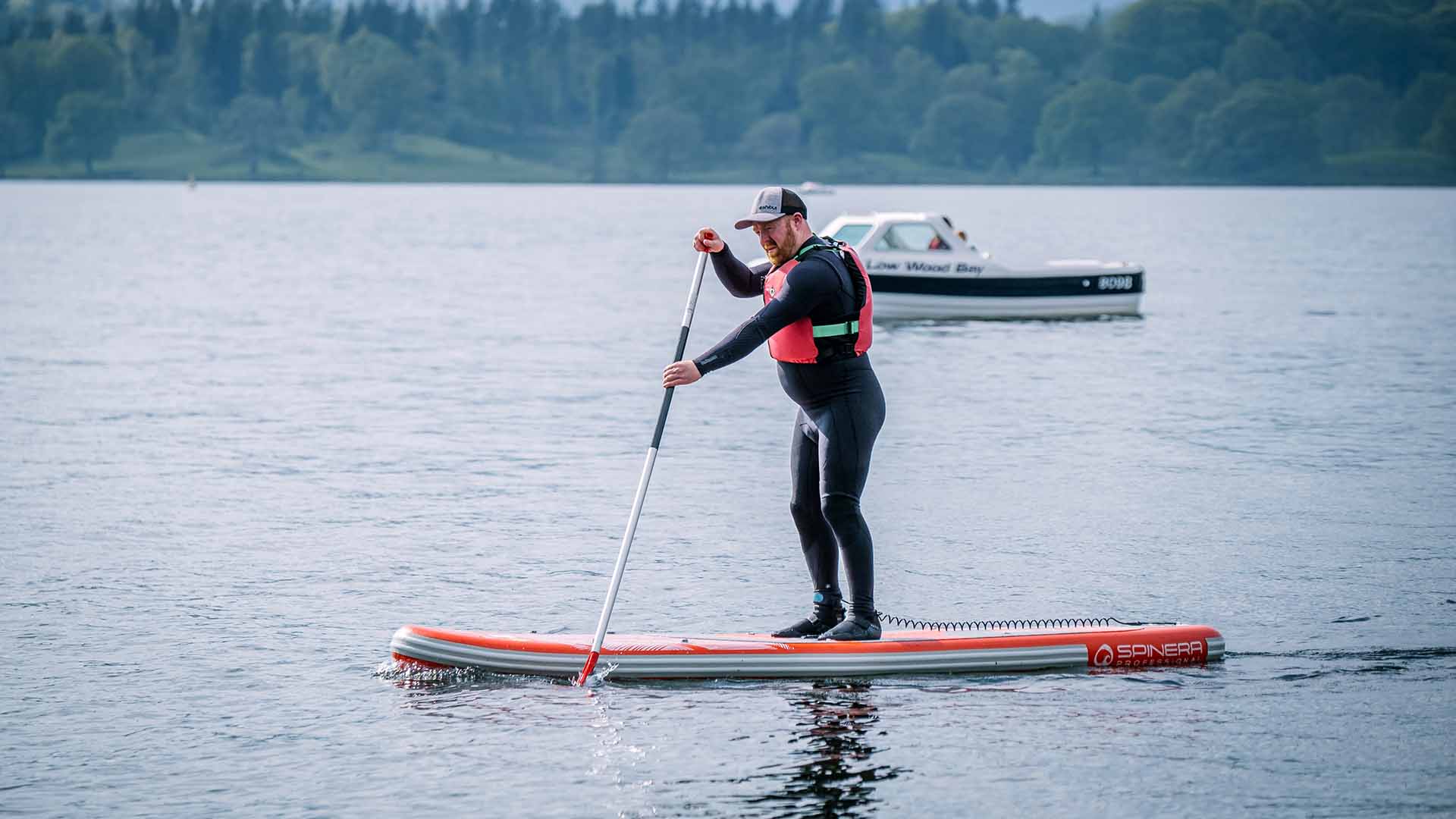 Man paddleboarding on lake winderemere