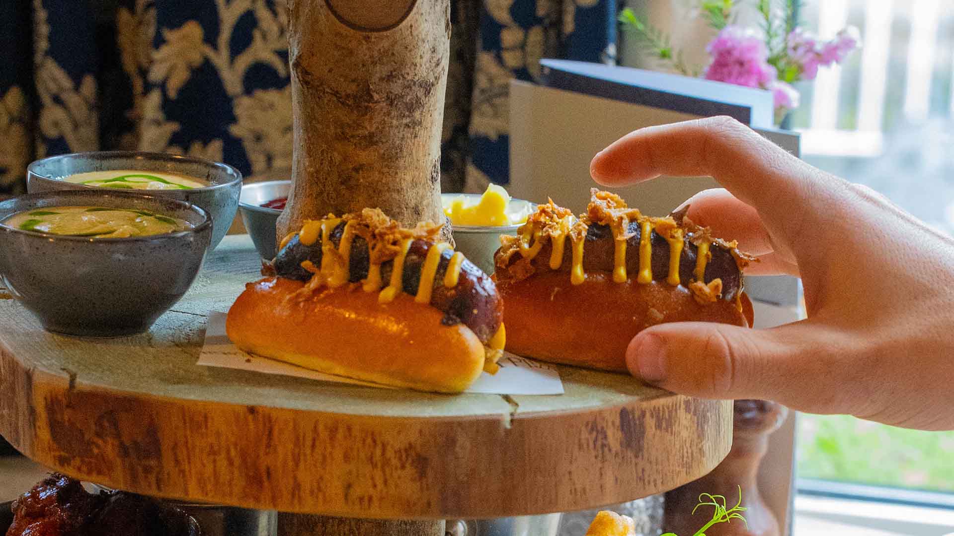 A hand reaching for a frankfurter
