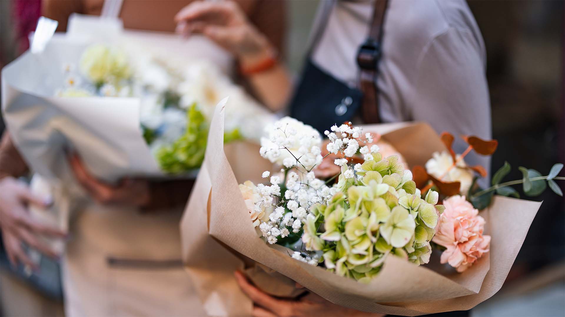 Women holding bouquets of flowers