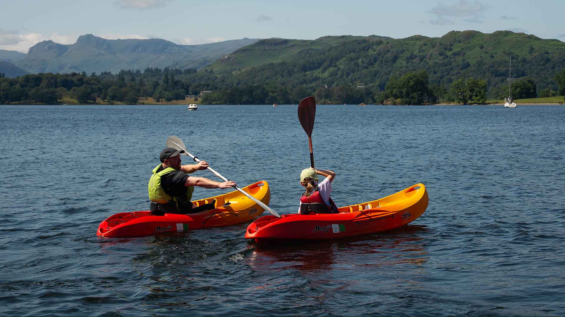 Two kayakers aboard hired kayaks on lake Windermere